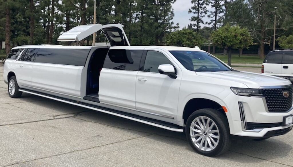 A white luxury SUV with gullwing doors open, revealing a spacious interior.