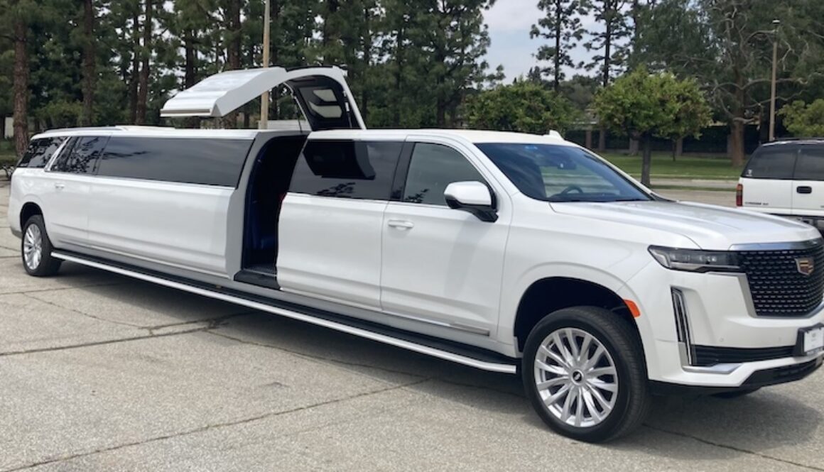 A white luxury SUV with gullwing doors open, revealing a spacious interior.