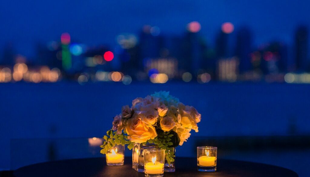 Table with candles and flowers with skyline in background