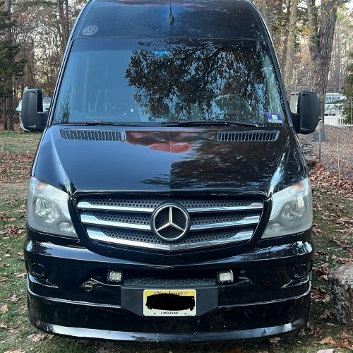 Front view of a black Mercedes-Benz Sprinter with JAC Limos license plate.