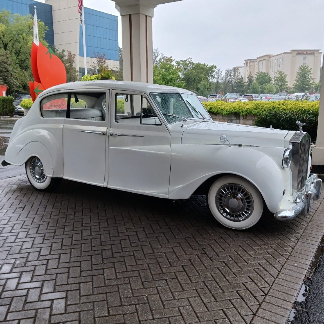 A white car parked in front of a building.