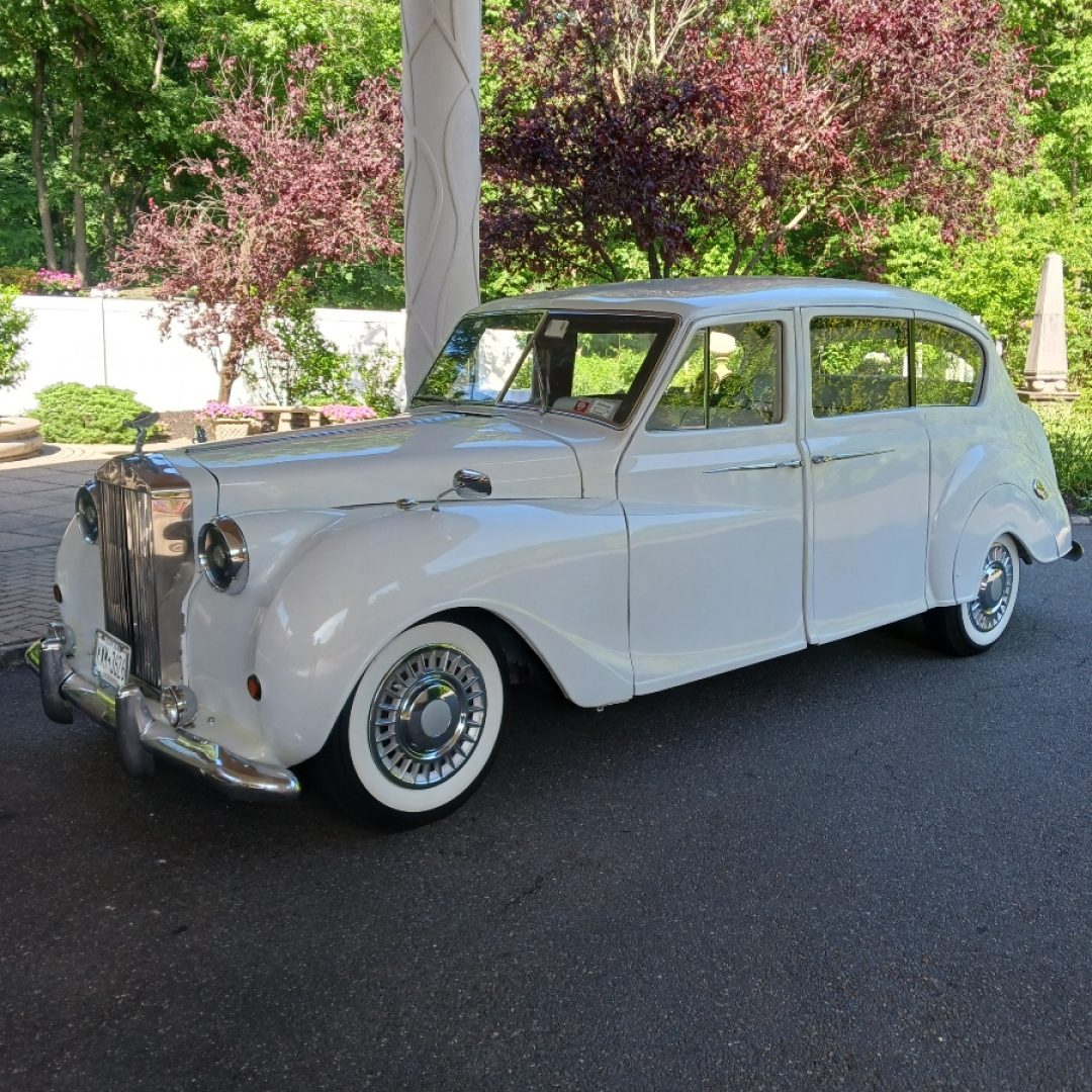 A white car parked on the side of a road.